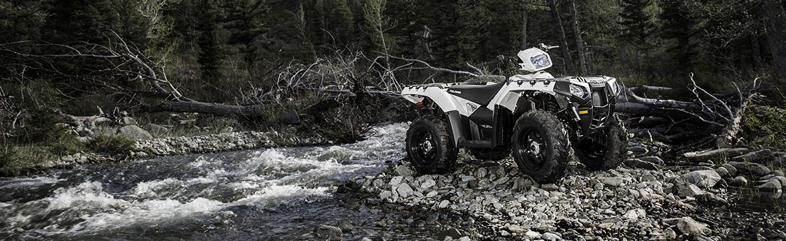 Polaris ATV On Rocks By Stream